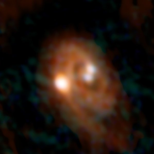 Immagine ottenuta combinando I dati di ALMA e VLA del sistema triplo L1448 IRS3B. Fonte: Combined ALMA Bill Saxton, ALMA (ESO/NAOJ/NRAO), NRAO/AUI/NSF
