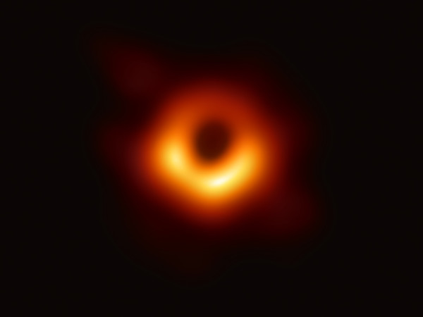 The Event Horizon Telescope (EHT) — a planet-scale array of eight ground-based radio telescopes forged through international collaboration — was designed to capture images of a black hole. In coordinated press conferences across the globe, EHT researchers revealed that they succeeded, unveiling the first direct visual evidence of the supermassive black hole in the centre of Messier 87 and its shadow. The shadow of a black hole seen here is the closest we can come to an image of the black hole itself, a completely dark object from which light cannot escape. The black hole’s boundary — the event horizon from which the EHT takes its name — is around 2.5 times smaller than the shadow it casts and measures just under 40 billion km across. While this may sound large, this ring is only about 40 microarcseconds across — equivalent to measuring the length of a credit card on the surface of the Moon. Although the telescopes making up the EHT are not physically connected, they are able to synchronize their recorded data with atomic clocks — hydrogen masers — which precisely time their observations. These observations were collected at a wavelength of 1.3 mm during a 2017 global campaign. Each telescope of the EHT produced enormous amounts of data – roughly 350 terabytes per day – which was stored on high-performance helium-filled hard drives. These data were flown to highly specialised supercomputers — known as correlators — at the Max Planck Institute for Radio Astronomy and MIT Haystack Observatory to be combined. They were then painstakingly converted into an image using novel computational tools developed by the collaboration.
